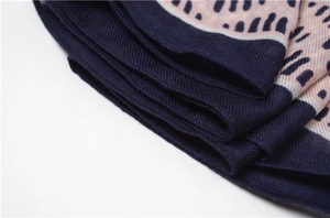 Macro shot showing the fine twill texture and neat stitching of the cotton linen scarf