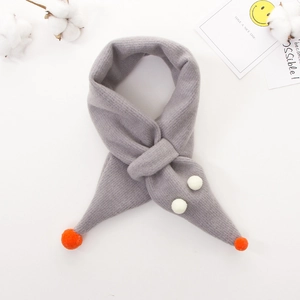 Grey knitted children's scarf with orange pompoms and soft texture on white background