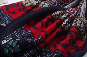 Detailed macro view of ethnic print scarf fabric with red and blue woven patterns