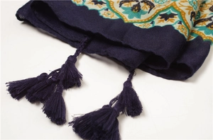 Detail shot of deep purple ethnic scarf with intricate mandala patterns and tassel fringe