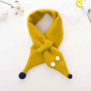 Detail of yellow knit children scarf with cute animal design and navy blue pom-pom accent