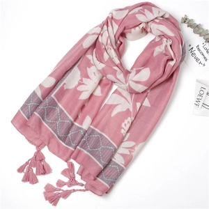 Detail of pink floral scarf with elegant fringe and leaf pattern texture