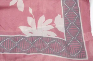 Detail of tropical floral print and geometric border on dusty rose cotton linen scarf