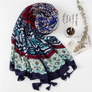 Detail view of ethnic navy blue shawl with geometric patterns and tassel edge decoration