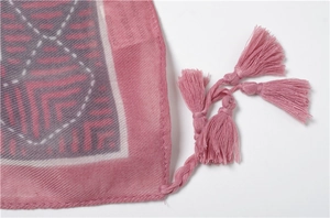 Detail of mauve linen scarf with geometric print and matching hand-crafted tassels