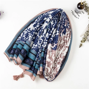Detailed close-up of retro floral cotton scarf with corner tassels and boho texture