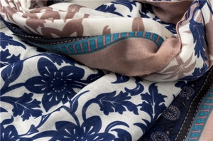 Macro detail of navy floral cotton linen scarf showing soft texture and woven fiber quality