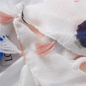 Close-up of lightweight cotton linen scarf showing pink blue abstract prints and fringe