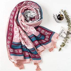Detail view of floral cotton linen scarf with elegant tassels and bohemian print texture
