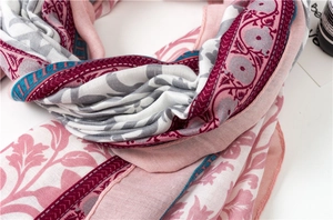 Detailed macro view of soft cotton-linen scarf with vintage bohemian floral patterns