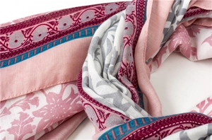Close-up of cotton linen scarf showing pink floral prints and soft fabric texture