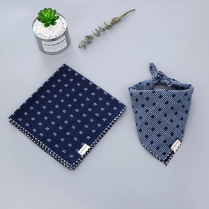 Detail of dark blue plaid cotton linen bib scarves with durable stitched brand label