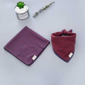 Close-up of red and blue checkered cotton baby scarves with delicate stitched edges