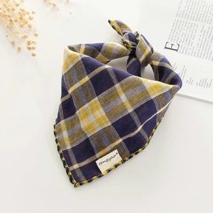 Detailed view of checkered cotton gauze baby bib with high-quality yellow edge stitching