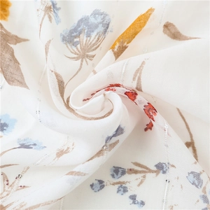 Detailed view of floral cotton linen scarf with silver silk threads and subtle sequins