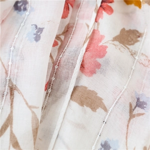Macro detail of floral cotton linen fabric with vertical sequins and slub texture