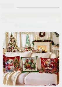 Three-piece Christmas cushion covers featuring snowman and Santa patterns on a sofa