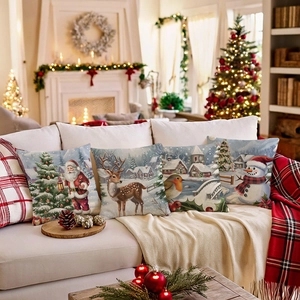Set of 4 Christmas faux linen pillow covers with Santa and reindeer on a white sofa