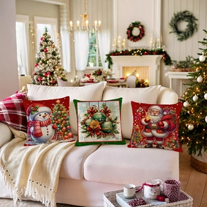 Set of 3 Christmas linen cushion covers featuring Santa and Snowman on a white sofa