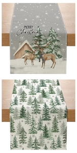 Detail of Christmas table runner with reindeer and snow cabin on a wooden table surface