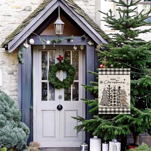 Christmas garden flag with Merry Christmas text and pine trees in a festive outdoor setting