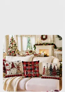 Detailed view of three festive Christmas pillow covers on a white sofa in a cozy room