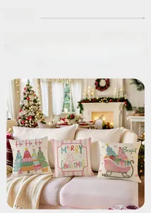 Three Christmas decorative throw pillow covers on a beige sofa near a lit fireplace