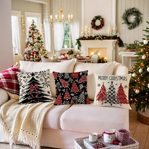 Three Christmas throw pillow covers with festive plaid and tree patterns on a white sofa