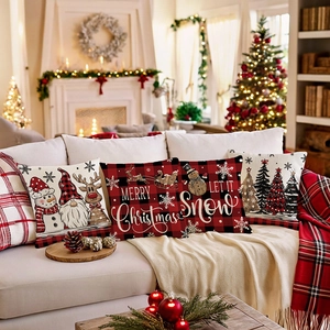 Set of 4 Christmas pillow covers with buffalo plaid, gnomes and reindeer on a sofa