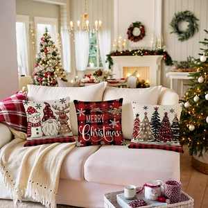 Set of three Christmas pillow covers with snowman and reindeer on white sofa with tree