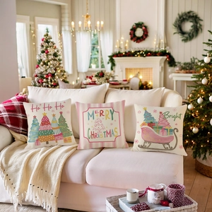 Three Christmas throw pillow covers with festive prints on a cozy white sofa