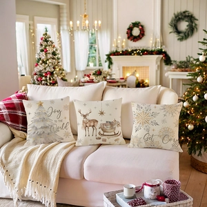 Set of three Christmas pillow covers with reindeer and snow scenery on a sofa