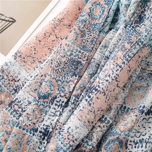 Detail of vintage mandala print on soft blue and pink cotton linen scarf with tassels