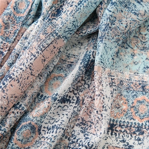 Detail of vintage totem pattern on soft cotton linen scarf with blue and pink floral motifs