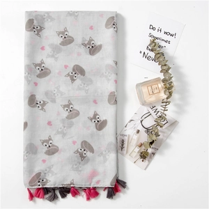 Light gray fox and heart print scarf with pink tassels on a minimalist background