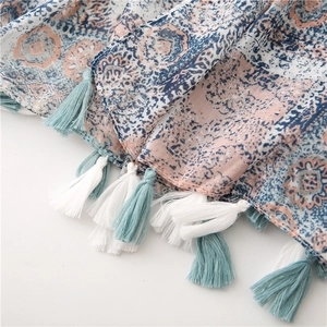 Close-up of vintage totem print scarf featuring bicolor tassels and mandala patterns