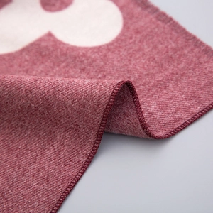 Detailed macro view of soft burgundy cashmere-like fabric with white floral pattern