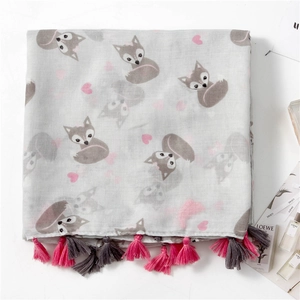 Detailed view of fox and pink heart print on grey scarf with vibrant colorful tassels