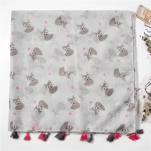 Close-up of gray scarf featuring fox patterns, heart prints and colorful tassel edges