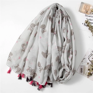 Detail of light gray scarf featuring fox patterns, pink hearts and bicolor fringe tassels