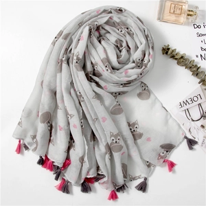 Close-up of artistic fox print and soft tassels on a grey cotton-linen scarf