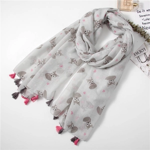 Detail of fox print scarf with pink tassels and decorative accessory styling