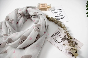 Detail shot of light grey scarf with fox and heart print on soft, breathable fabric