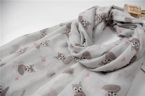 Detail of light gray scarf featuring cartoon fox print and pink hearts with fringe