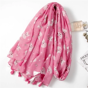 Detail of pink scarf showing cute cat and heart patterns with soft fringe tassels