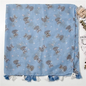 Detail of light blue scarf featuring cartoon fox prints and fringed tassel edges