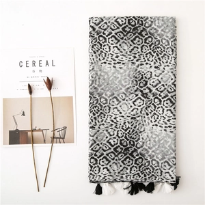 Châle léopard noir et blanc avec pompons et fond de magazine Cereal minimaliste