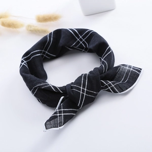Detail view of the black and white gingham linen scarf with a decorative bow knot