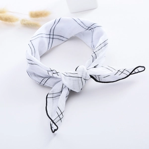 Detail of soft cotton linen kids scarf featuring black grid pattern and hemmed edges