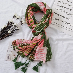 Tropical palm leaf print scarf with green tassels made of light cotton linen fabric